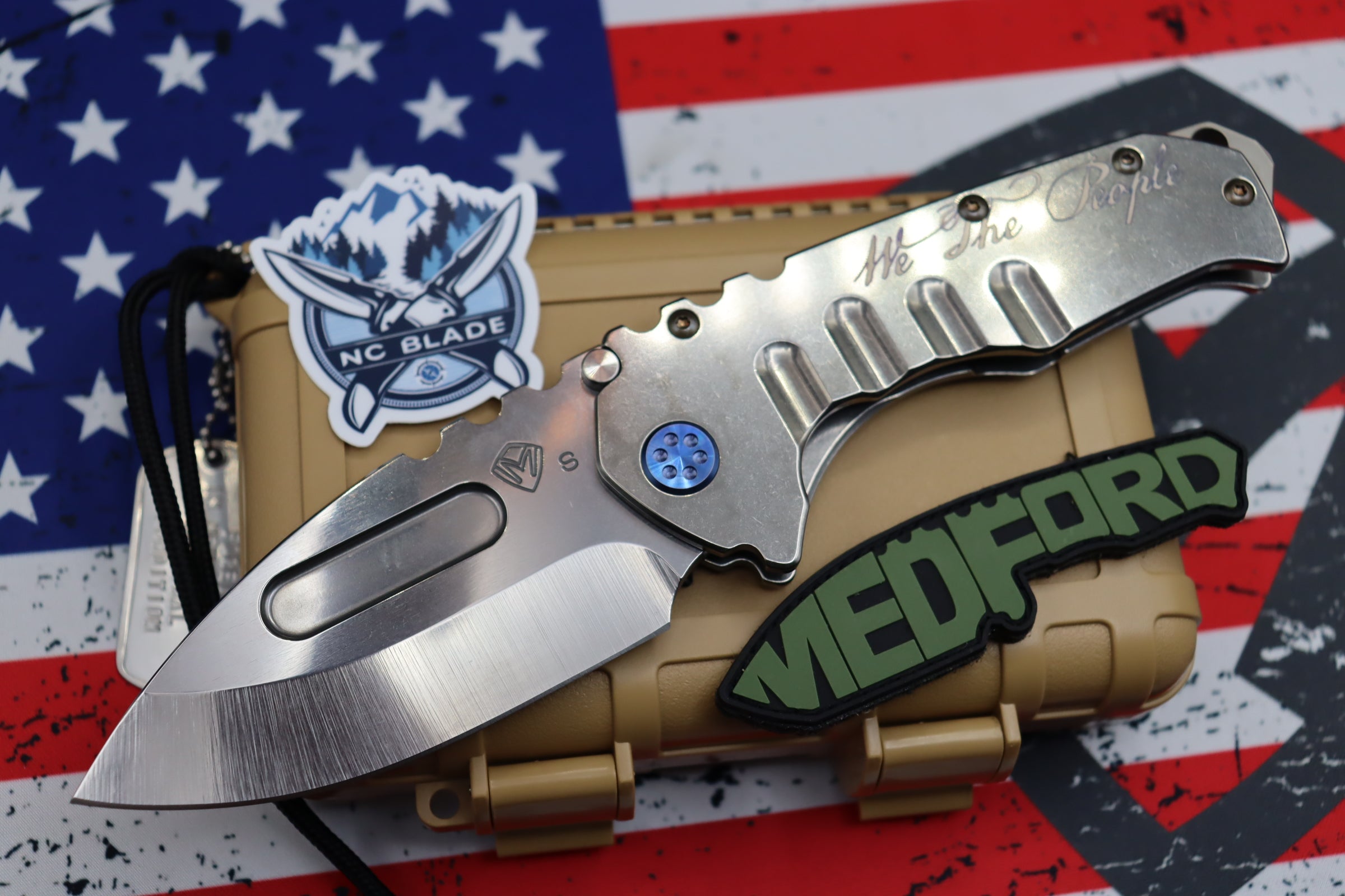 Medford Knife Praetorian T “We The People” Engraved & Blue Hardware with S35 Drop Point 106-047