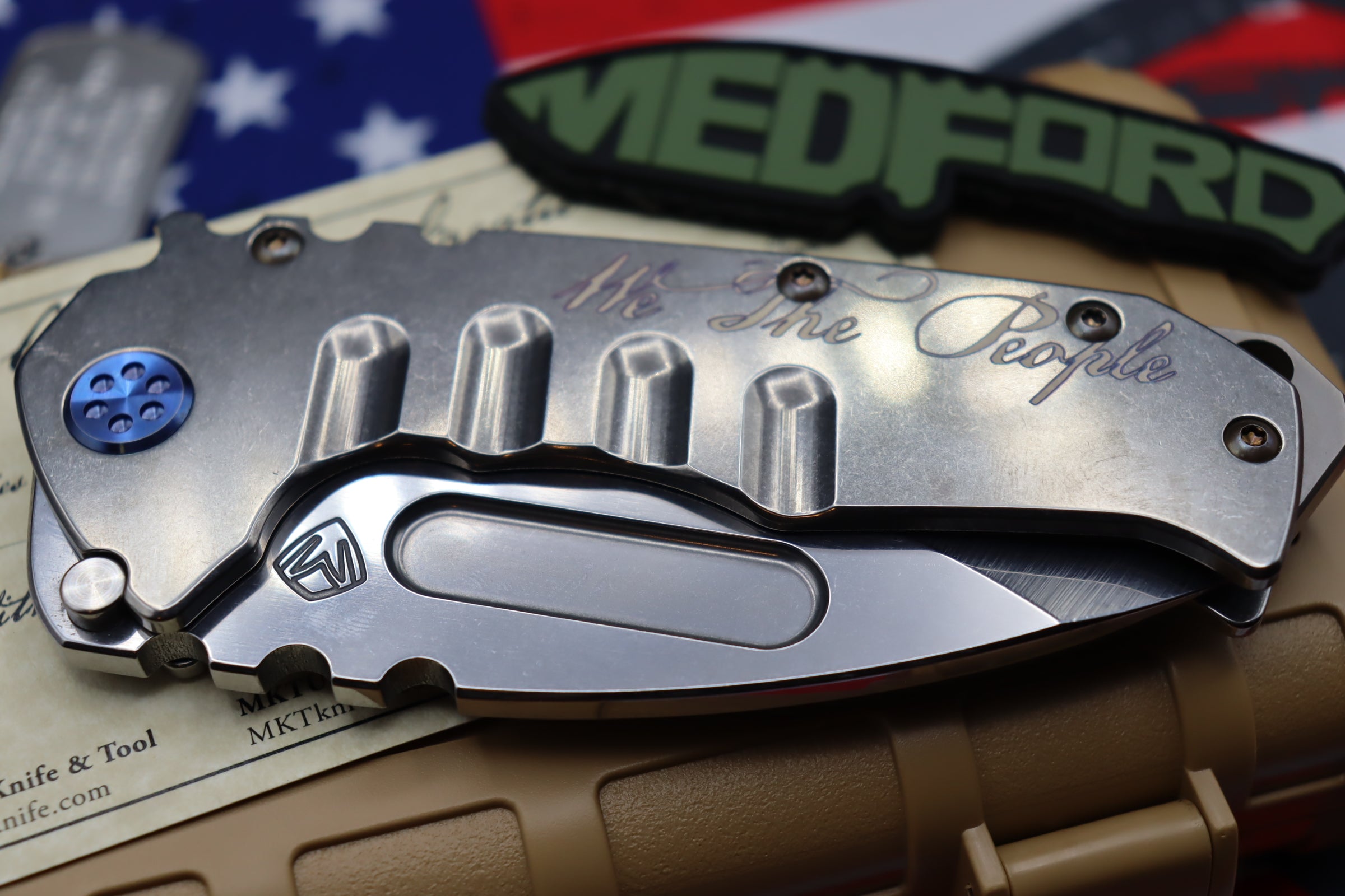 Medford Knife Praetorian T “We The People” Engraved & Blue Hardware with S35 Drop Point 106-047