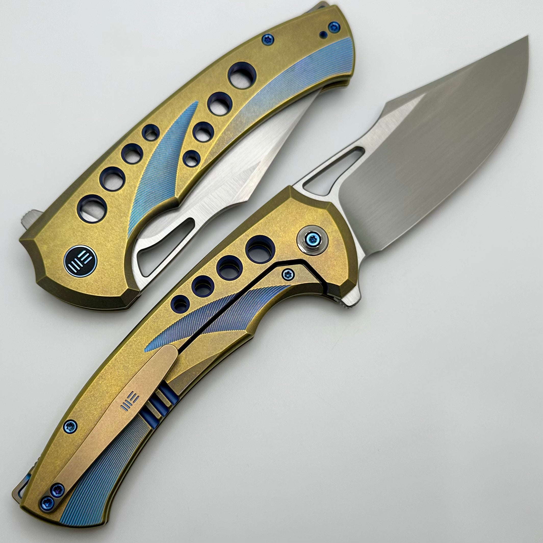 We Knife Swiftfin Golden/Blue Titanium Handles w/ Blue Holes & Hand Satin 20CV WE23051-4