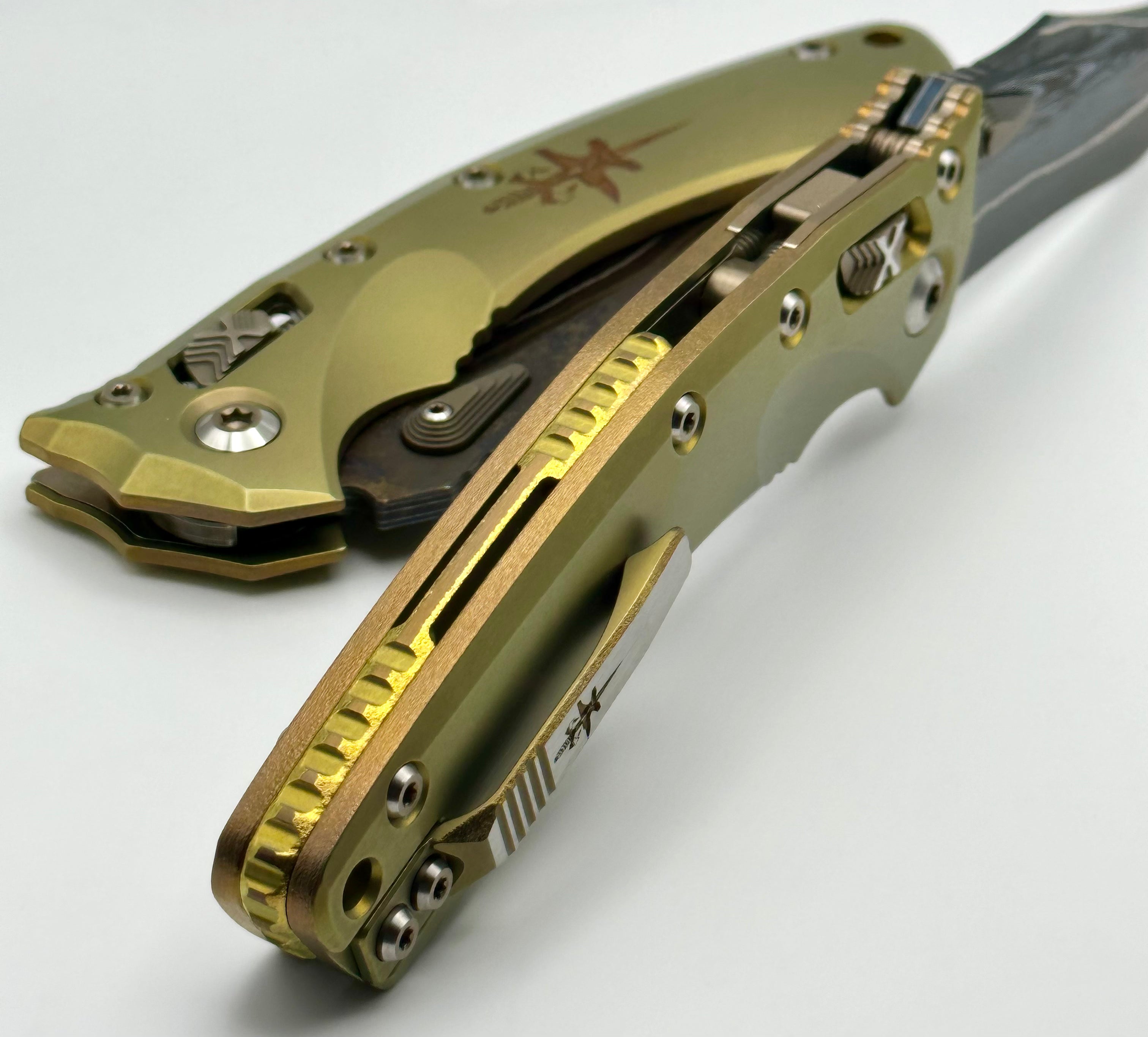 Marfione Custom Knives Amphibian RAM-LOK Terraform Pattern Broken Anvil Damascus & Sovereign Gold Stippled Titanium w/ Joint Logo Dagger Engraved & Two Tone Bronzed Hardware