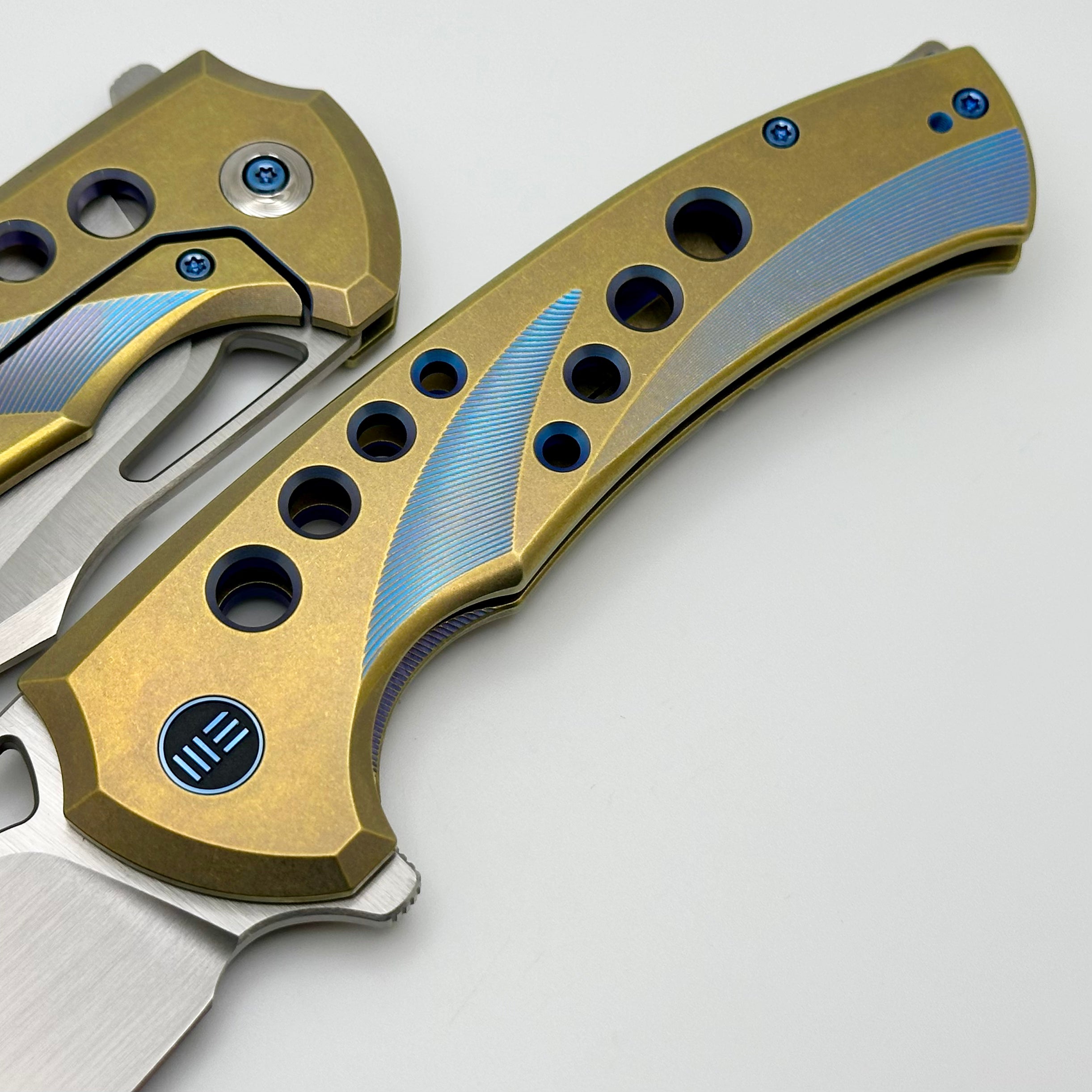 We Knife Swiftfin Golden/Blue Titanium Handles w/ Blue Holes & Hand Satin 20CV WE23051-4