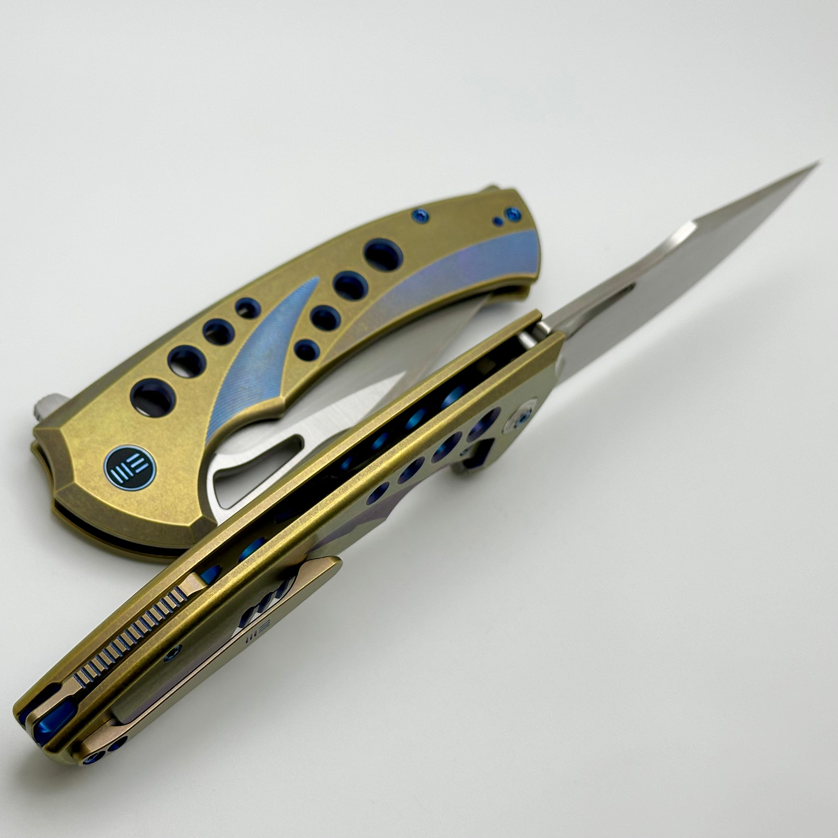 We Knife Swiftfin Golden/Blue Titanium Handles w/ Blue Holes & Hand Satin 20CV WE23051-4