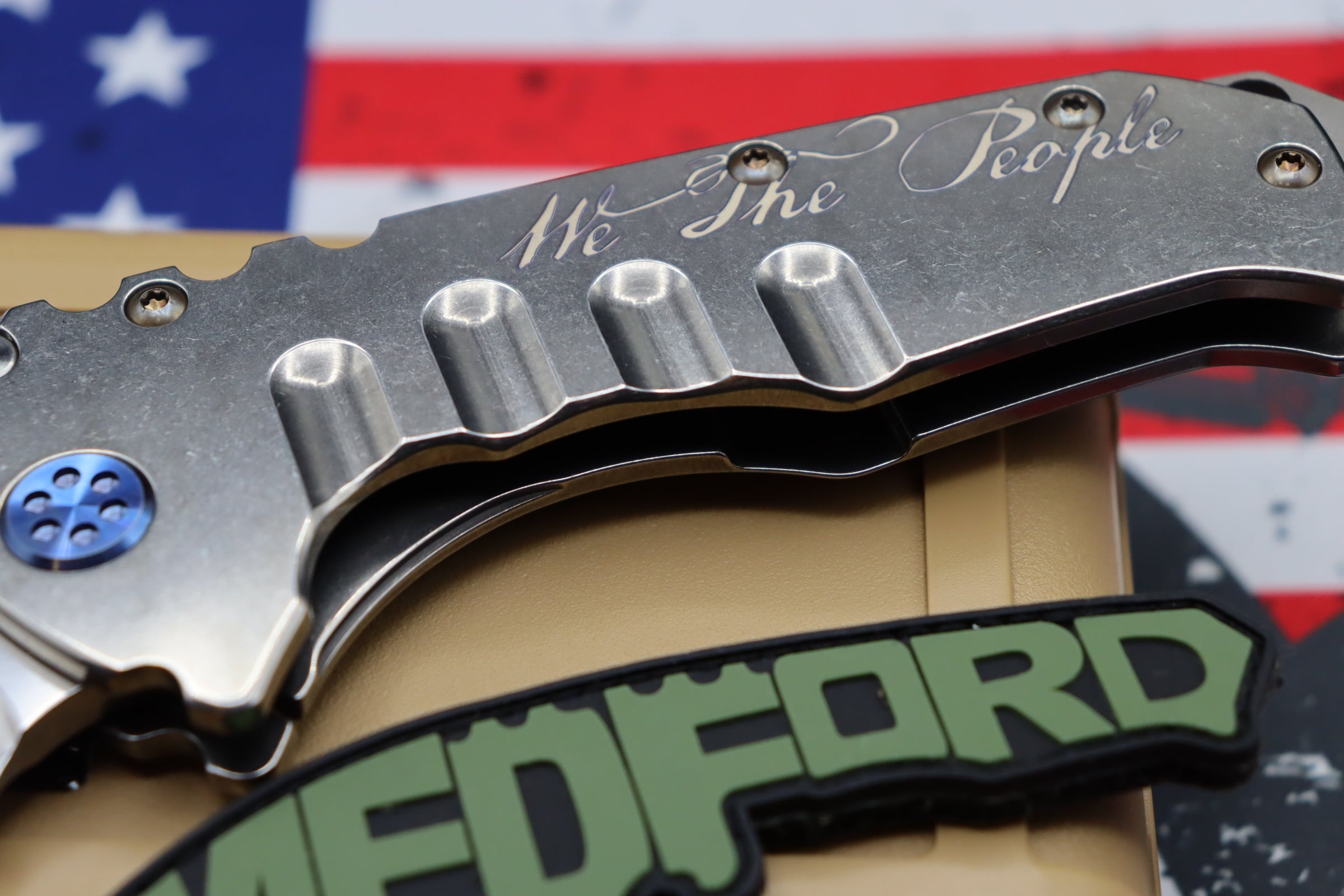 Medford Knife Praetorian T “We The People” Engraved & Blue Hardware with S35 Drop Point 106-047