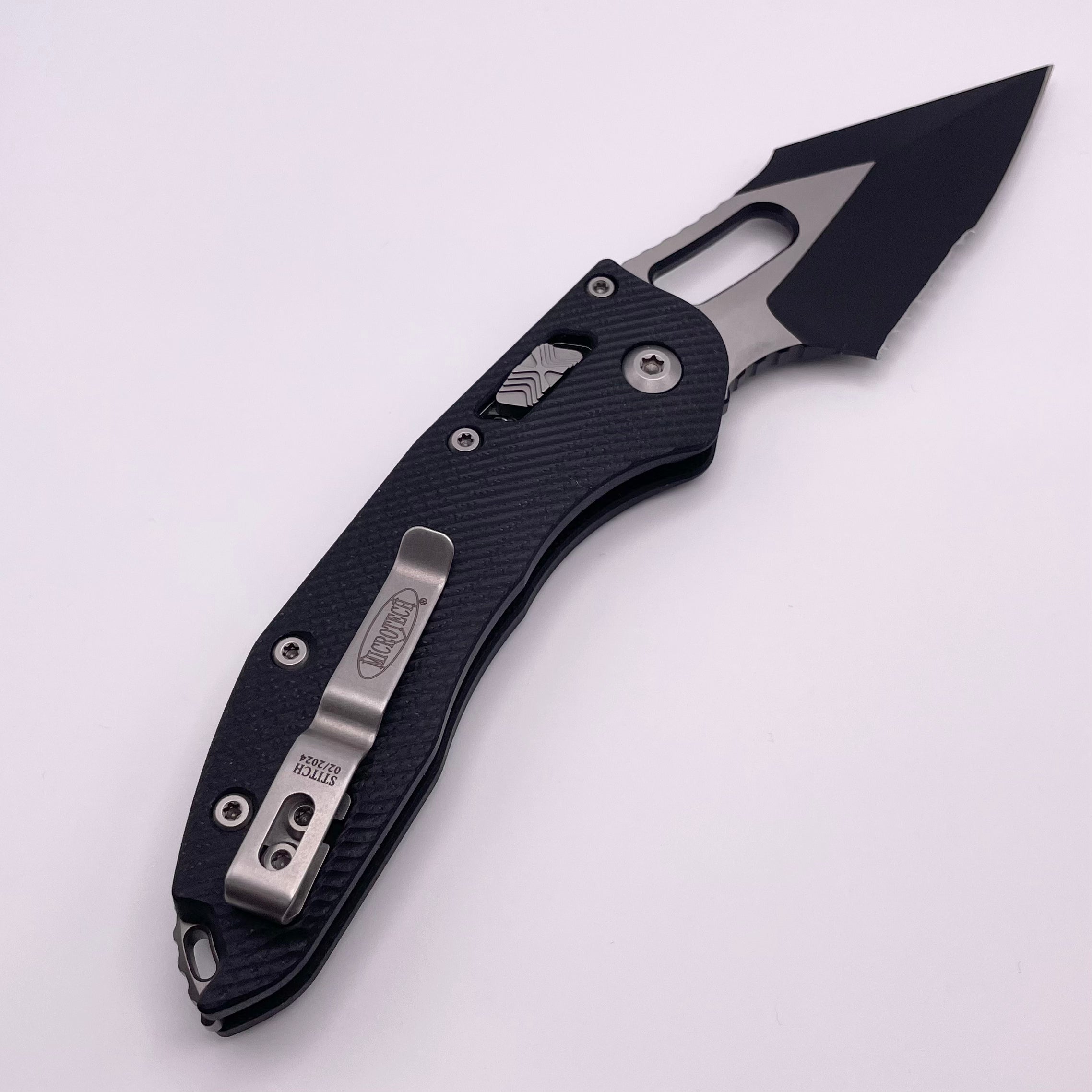 Pre Owned Microtech Knives Manual Stitch RAM LOK Fluted Black G-10 & Partial Serrated Two Tone Black M390MK 169RL-2FLGTBK