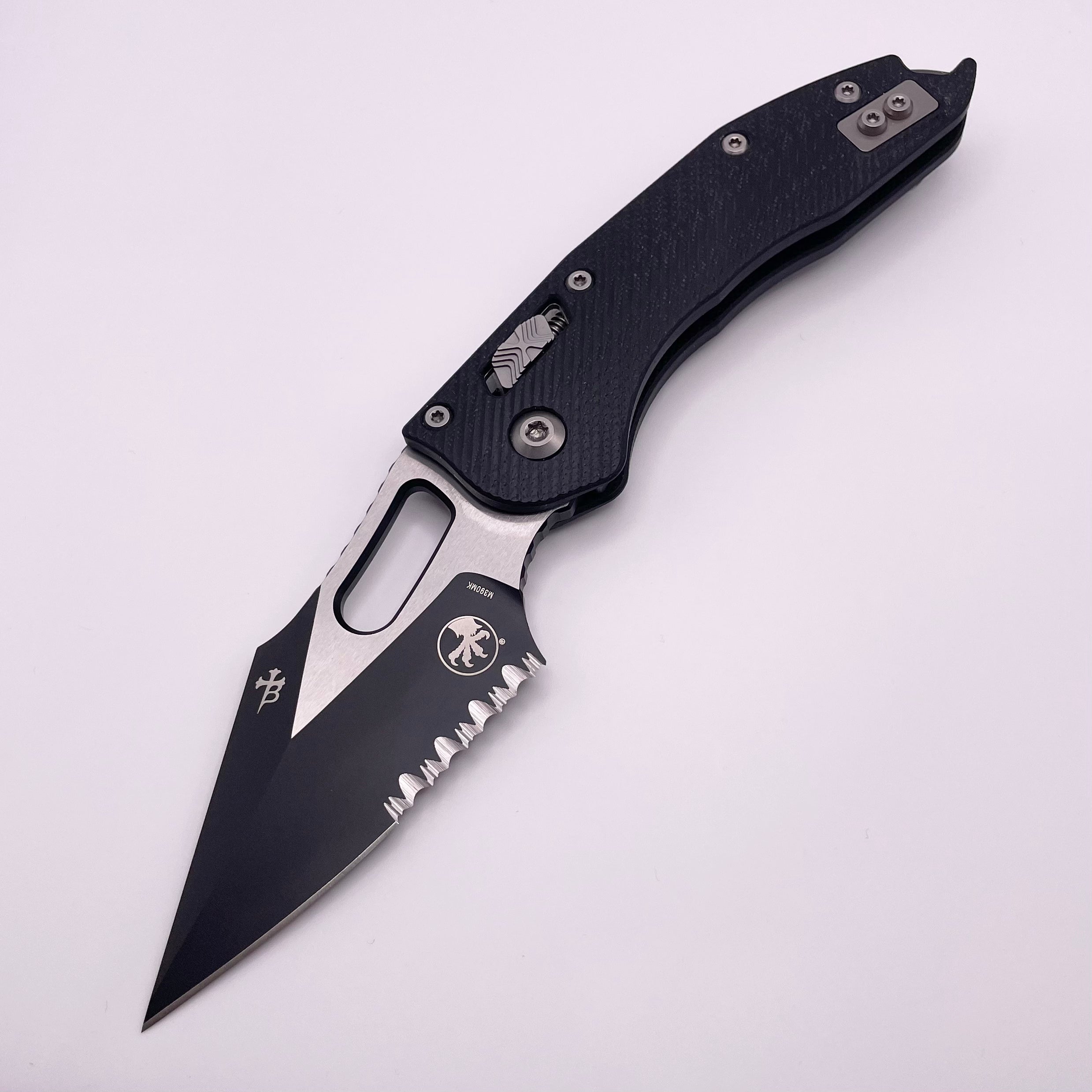 Pre Owned Microtech Knives Manual Stitch RAM LOK Fluted Black G-10 & Partial Serrated Two Tone Black M390MK 169RL-2FLGTBK