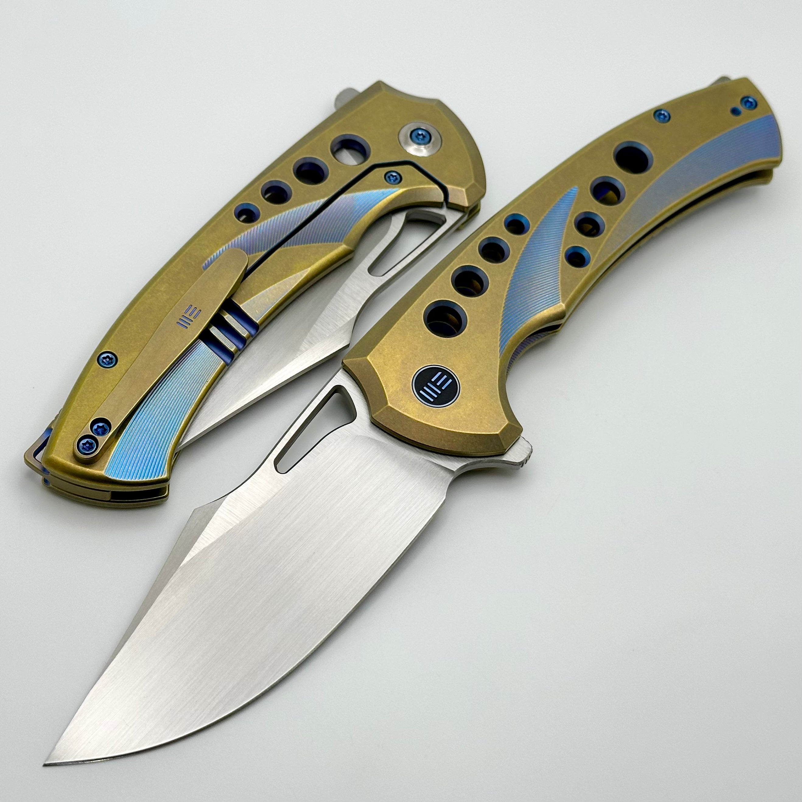 We Knife Swiftfin Golden/Blue Titanium Handles w/ Blue Holes & Hand Satin 20CV WE23051-4